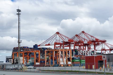 Container cranes and stacked containers at a commercial port