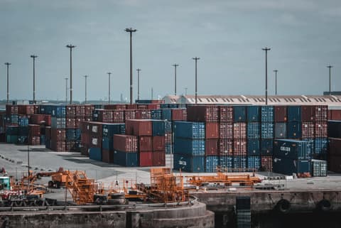 Stacked shipping containers in a port yard